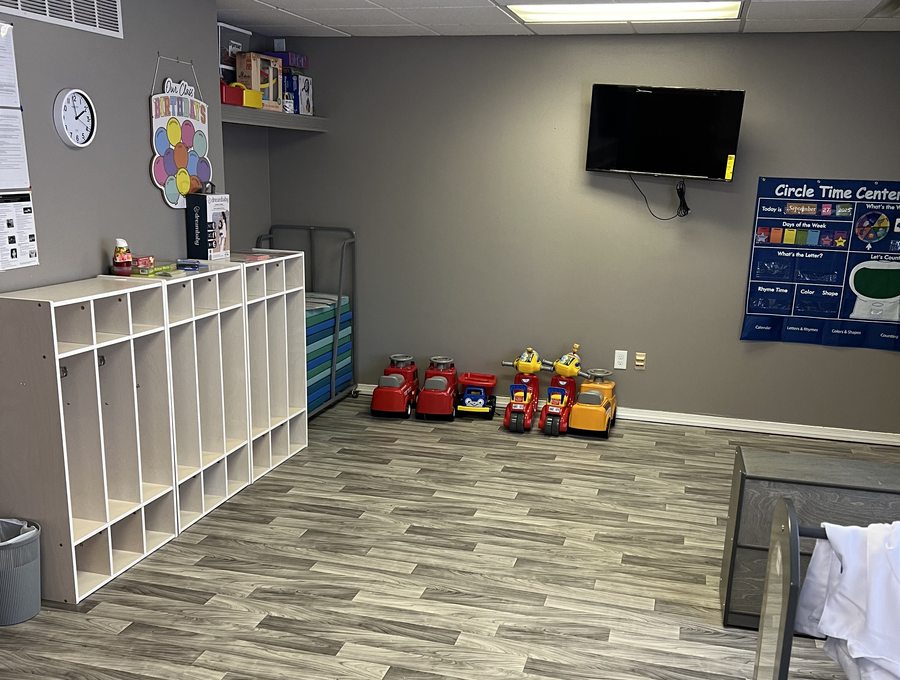 Bright child care classroom with organized cubbies and play areas