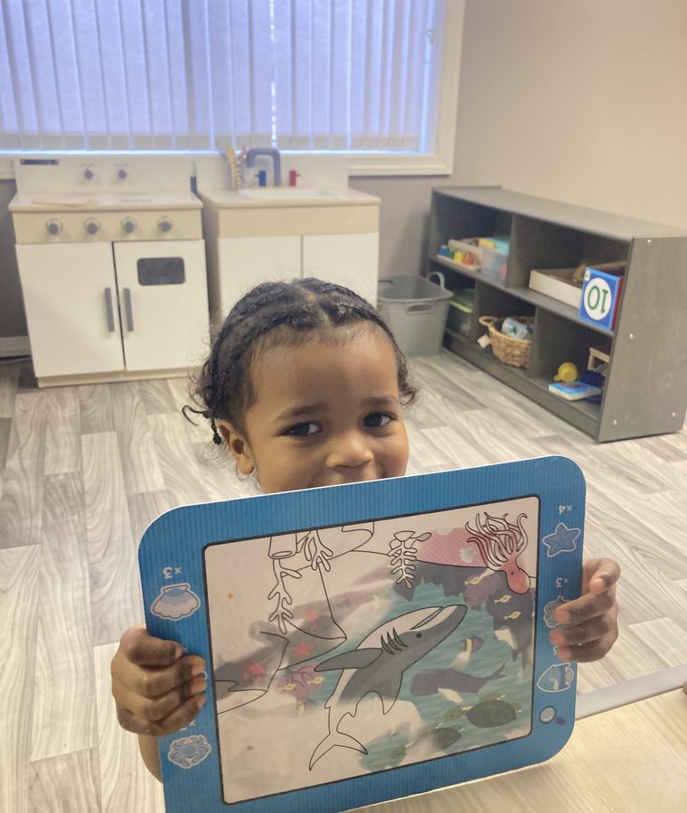 Young child showing a completed learning activity