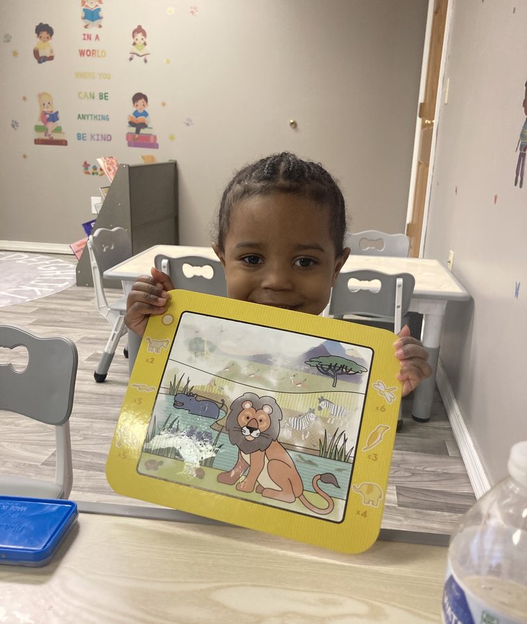 Child holding a completed story-themed art project